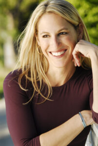 this smile woman name is Jill Brown, professional stuntwoman with long dark blonde hair, showcasing her action stunt expertise